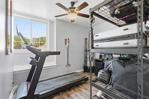 Workout area with wood finished floors and a ceiling fan