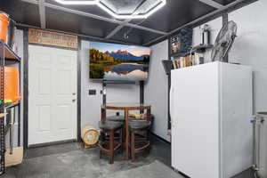 Basement featuring freestanding refrigerator