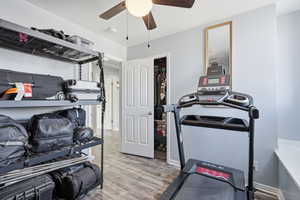 Workout room featuring light wood-type flooring and ceiling fan