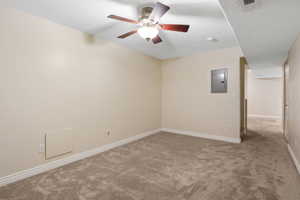 Carpeted room featuring a ceiling fan with integrated lighting, a neutral paint palette, and white baseboards