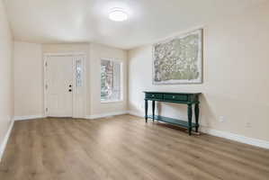 Entrance foyer featuring light wood-style floors and baseboards