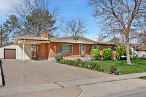 View of front of the home with carport and large detached garage