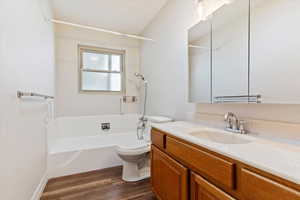 Hallway bathroom with vanity, shower / bath combination