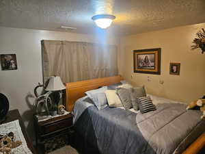 Bedroom featuring a textured ceiling