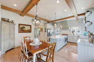Dining area featuring beamed ceiling, quarter sawn white oak flooring, RH chandelier