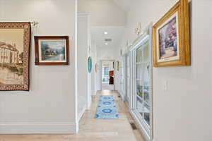 Hall featuring quarter sawn white oak flooring and recessed lighting, leading to the master suite