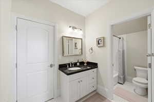 Bathroom featuring vanity, divided from shower / bath and toilet area