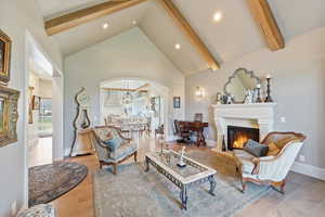 Living area featuring quarter sawn white oak flooring, vaulted ceiling, and fireplace