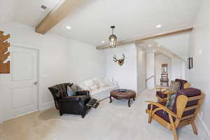 Living room featuring light colored carpet, recessed lighting, and ceiling with beams