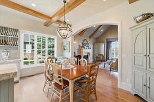 Dining area featuring beam ceiling, quarter sawn white oak flooring, RH chandelier