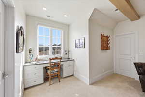 Office space with light carpet, built in study area, and recessed lighting