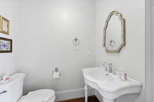 Half bathroom featuring toilet and beautiful fixtures