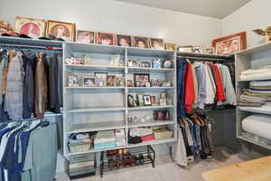Walk in master closet featuring great shelving and lots of space