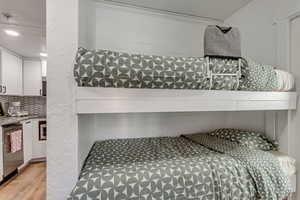 Bedroom featuring a textured wall and light wood-type flooring