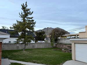 Fenced backyard featuring a mountain view