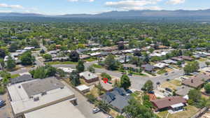 Residential neighborhood with mature tree coverage and distant mountain backdrop