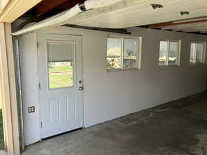 View of exterior entry featuring a patio and stucco siding