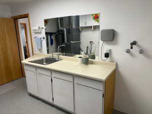 Kitchen featuring white cabinetry, light countertops, and light floors