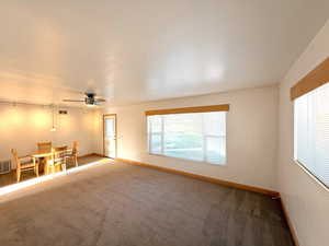 Spare room with carpet, healthy amount of natural light, and a ceiling fan
