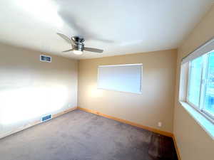 Empty room with carpet flooring and ceiling fan