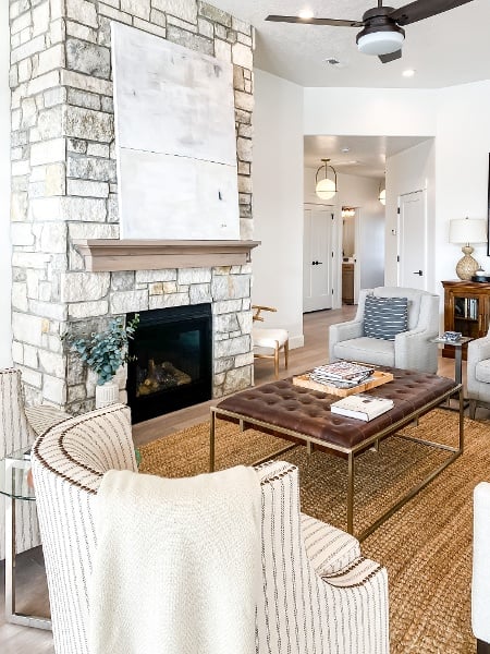 Living room featuring a ceiling fan, a fireplace, and wood finished floors