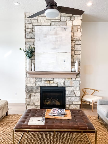 Detailed view of a textured ceiling, recessed lighting, a fireplace, and wood finished floors