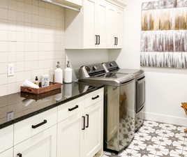 Laundry room featuring washing machine and clothes dryer and cabinet space