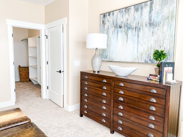 Bedroom with light colored carpet and baseboards