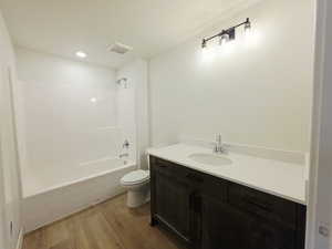 Bathroom with vanity, light wood-style flooring, and tub / shower combination