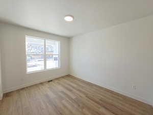 Empty room featuring light wood-style floors and baseboards