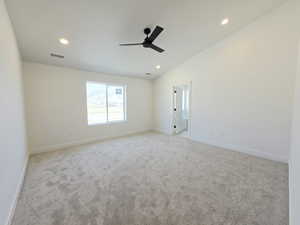 Unfurnished room featuring light carpet, vaulted ceiling, a ceiling fan, and recessed lighting