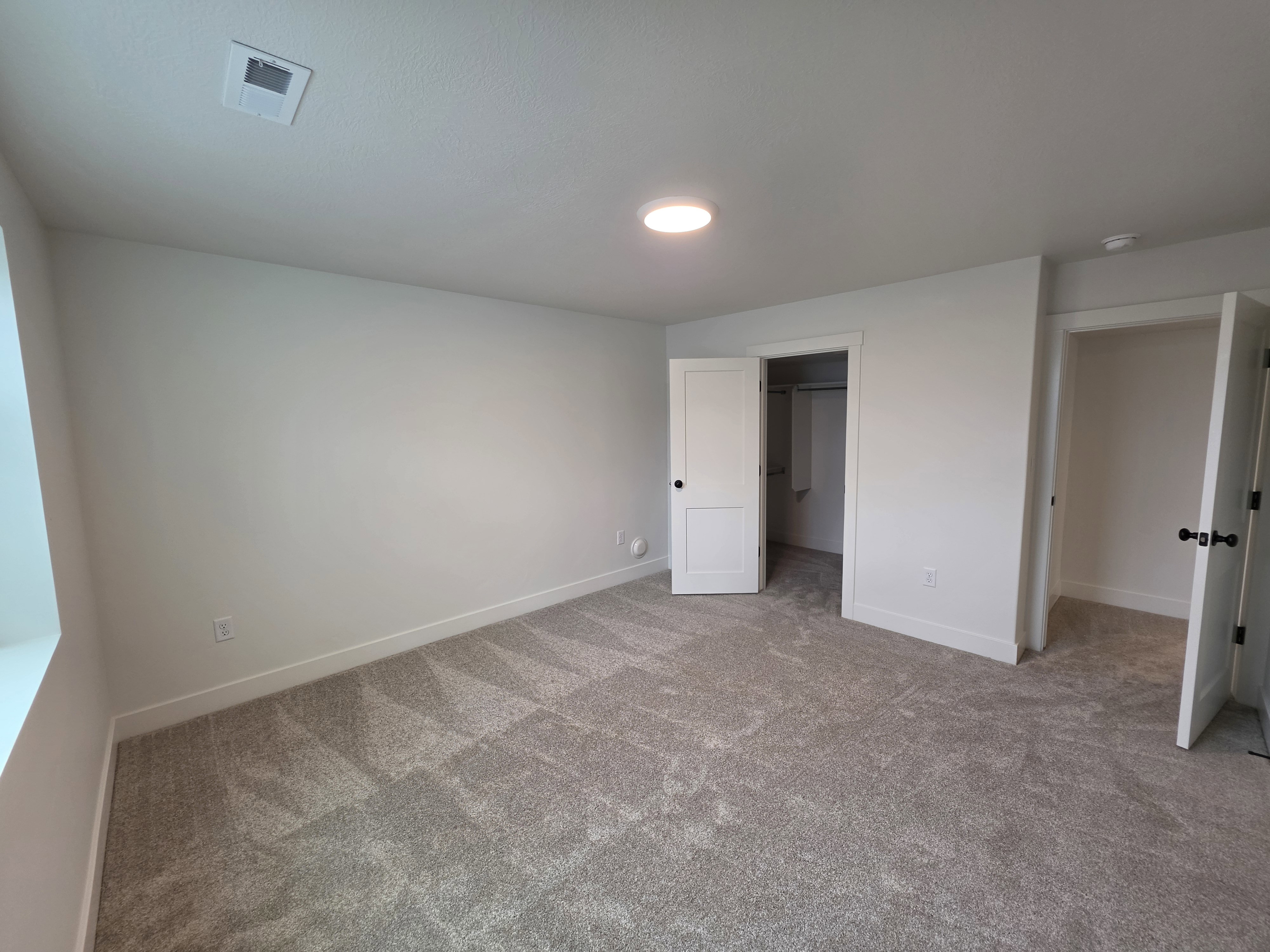 Carpeted room featuring white walls, a recessed ceiling light, and white trim