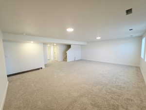 Finished basement featuring light colored carpet and recessed lighting