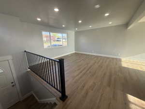 Unfurnished room with dark wood-style floors and recessed lighting