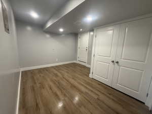 Finished below grade area with dark wood finished floors and recessed lighting
