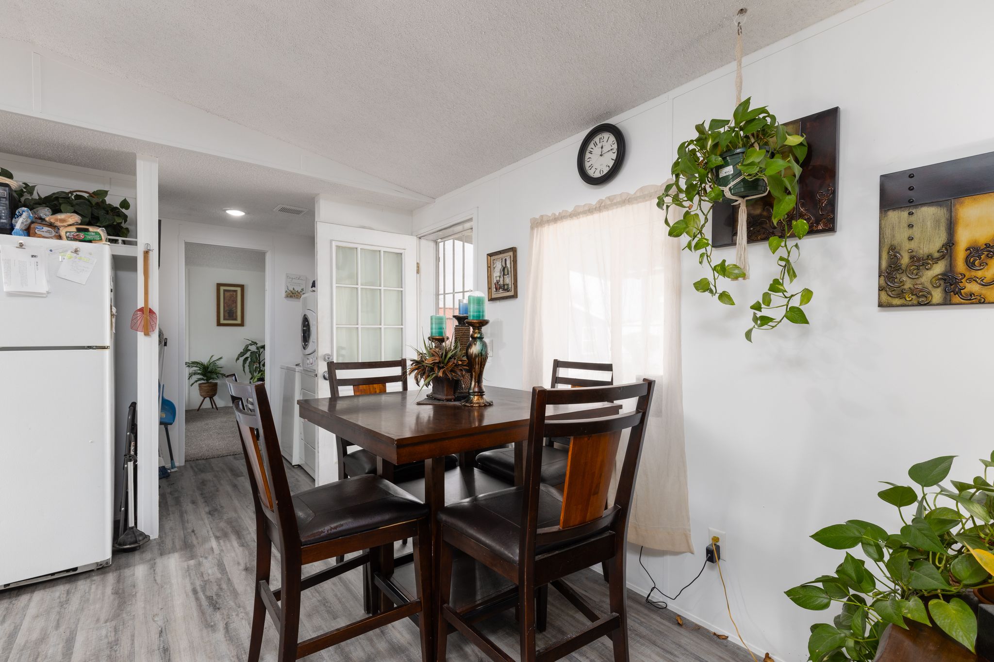 Dining space with light wood-style floors, a textured ceiling, and washer / clothes dryer