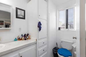 Half bathroom with vanity and toilet