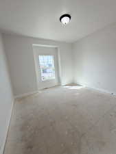 Spare room featuring baseboards