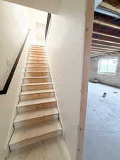 Staircase featuring concrete flooring