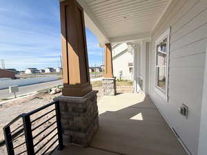 Covered porch featuring a residential view