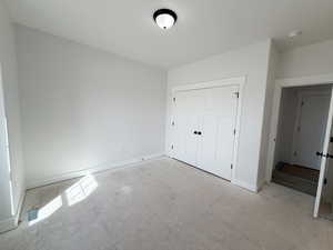 Unfurnished bedroom with baseboards and a closet