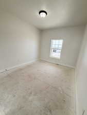 Empty room featuring baseboards