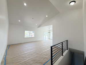 Spare room with vaulted ceiling and recessed lighting