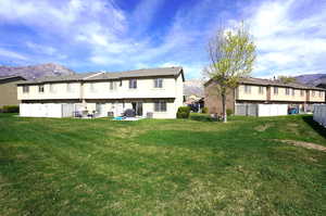 Rear view of house featuring a mountain view, a patio, and a residential view