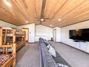 Living area featuring recessed lighting, ceiling fan, carpet flooring, and a wood ceiling with exposed beams