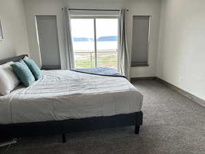 Bedroom featuring carpet floors and a water and mountain view