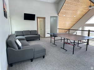 Game room with a ceiling fan and a vaulted wood ceiling