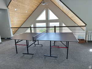 Recreation room featuring ceiling fan and a high wooden ceiling