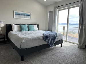 Carpeted bedroom featuring access to outside and a water view
