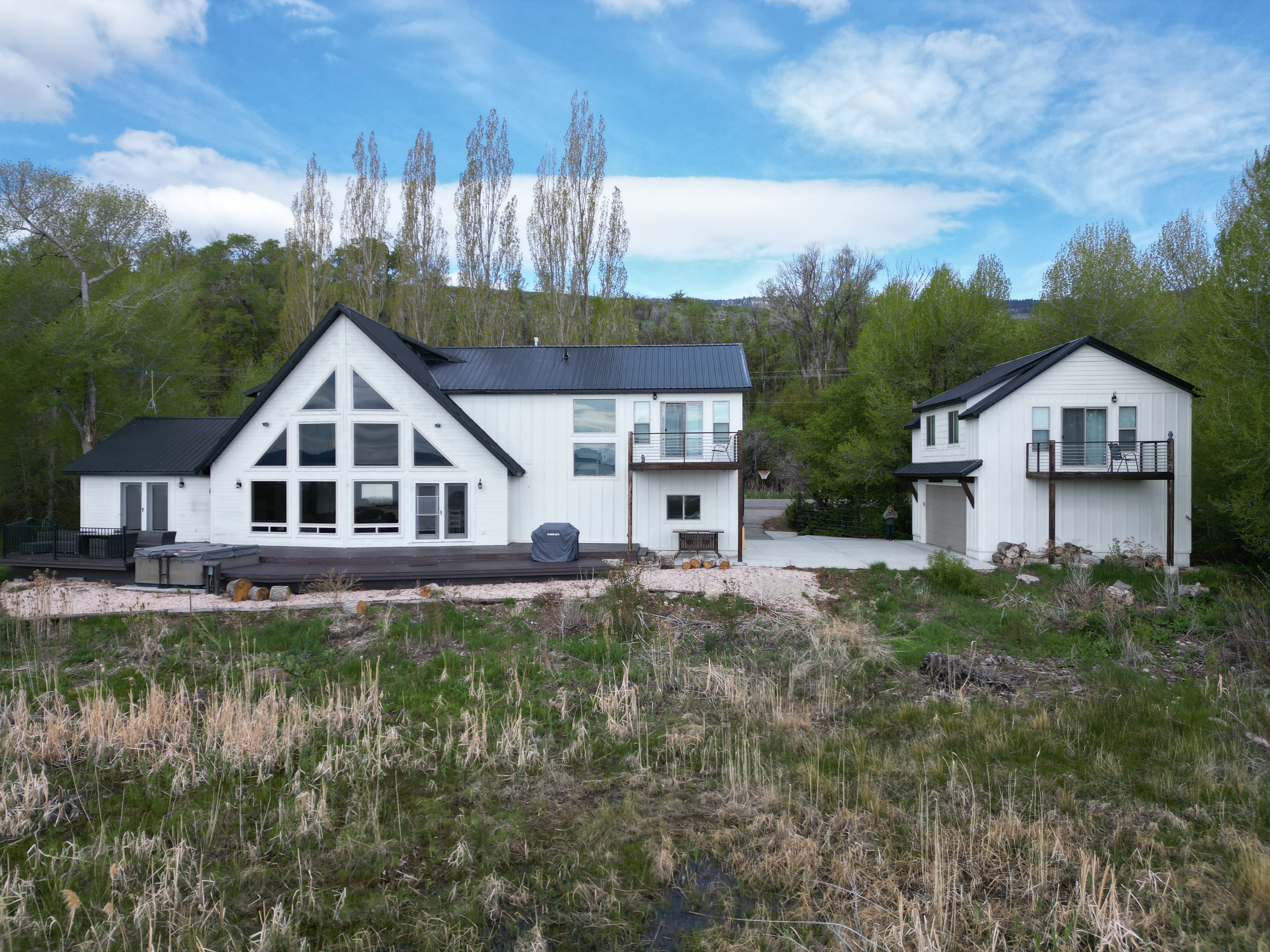 Back of property featuring a metal roof and a garage